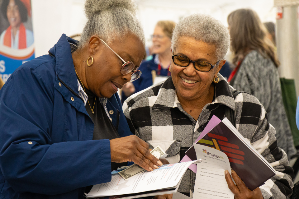 Two women at a mission festival