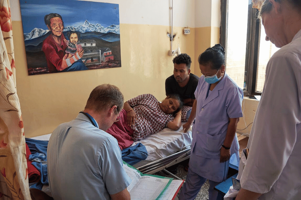 Doctor visiting patients in rehab area
