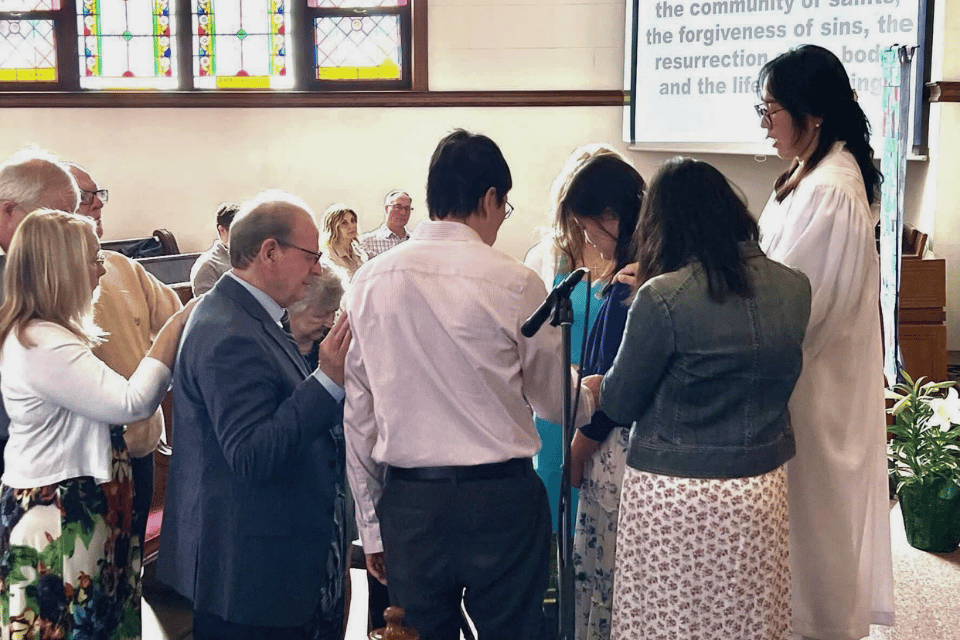 Young adult being prayed over