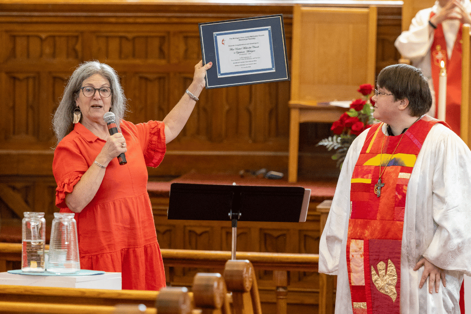 Woman holding proclamation honoring the church's bicentennial