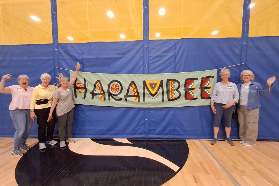 Volunteers standing in front of a sign