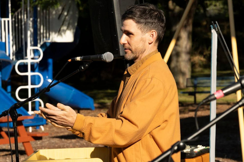 Artist speaking at a podium