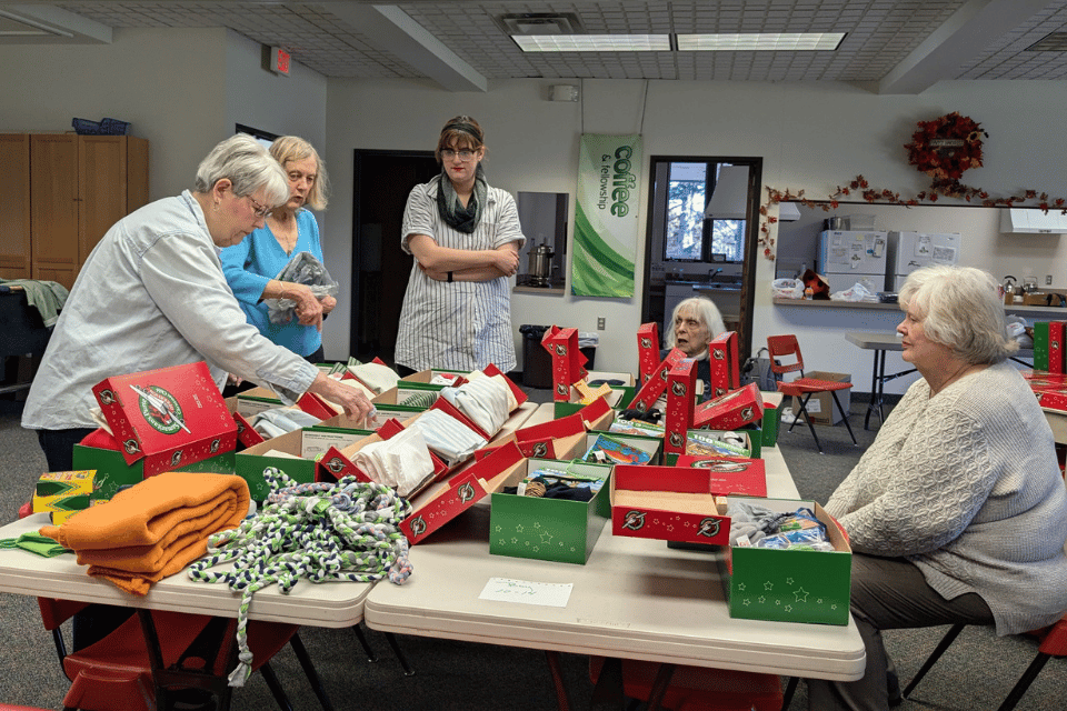 Church volunteers packing boxes for holiday gifts
