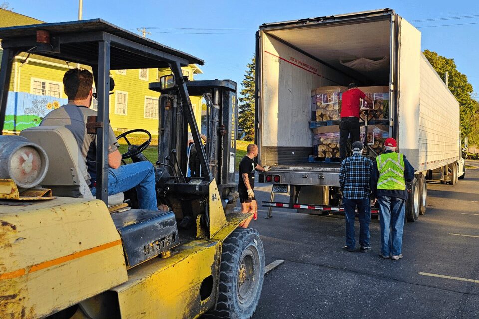 Forklift moving pallets of potatoes