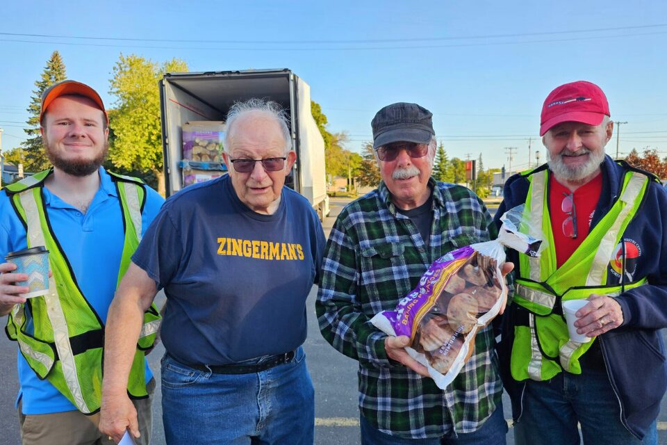 Volunteers passing out free potatoes