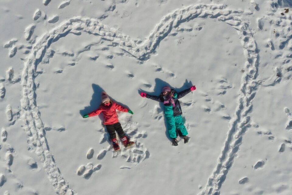 Two kids playing in the snow