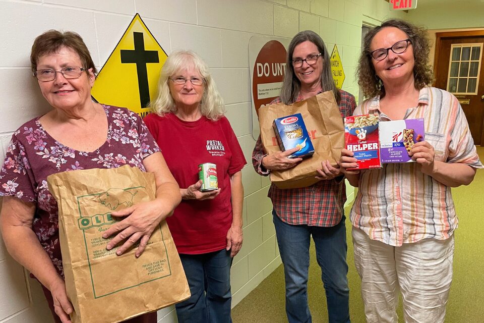Food pantry volunteers holding groceries