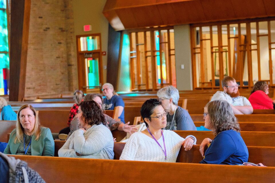 People talking in a church sanctuary
