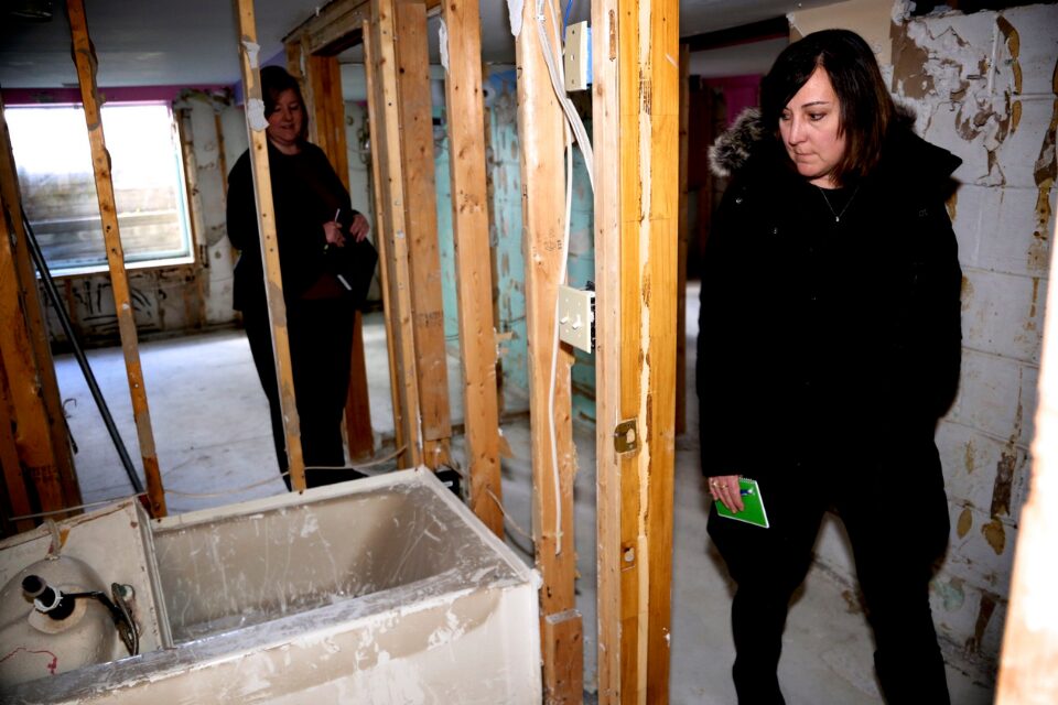 Staff reviewing storm damage to a home