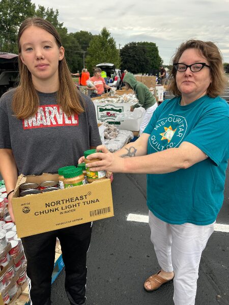 Church volunteers handing out food at a distribution