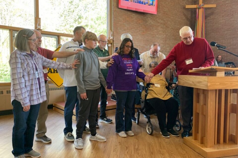 Church members praying with woman