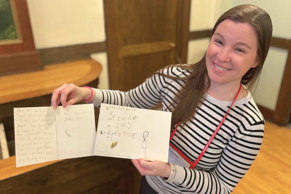 Mom holding cards made by her children