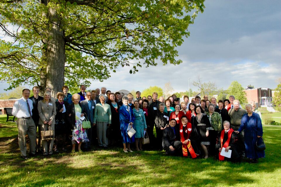 Congregation surrounding man being ordained