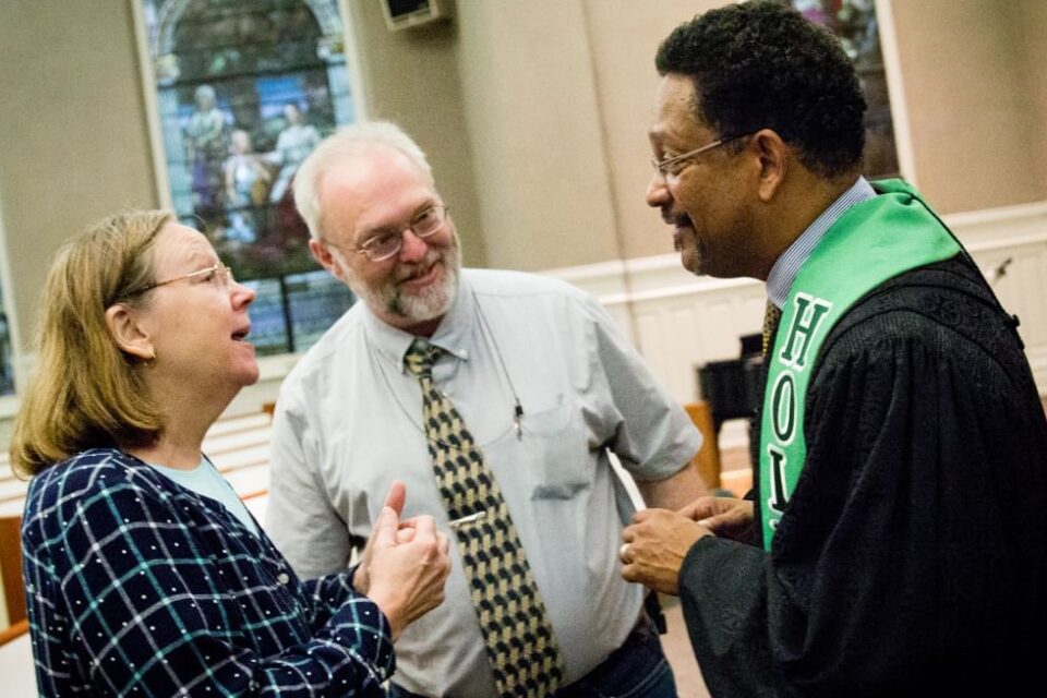 Pastor talking to church members