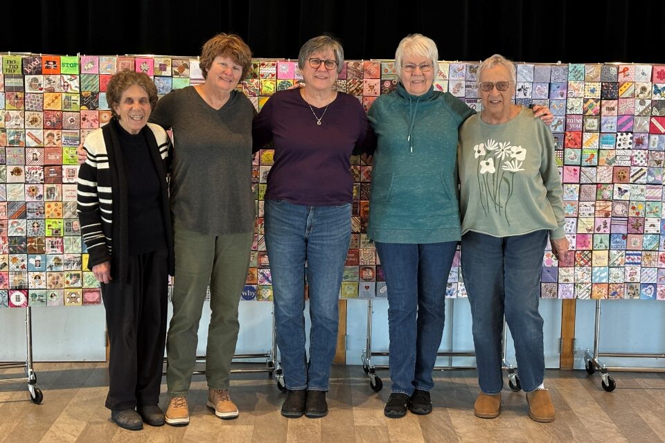 Volunteers in front of art display