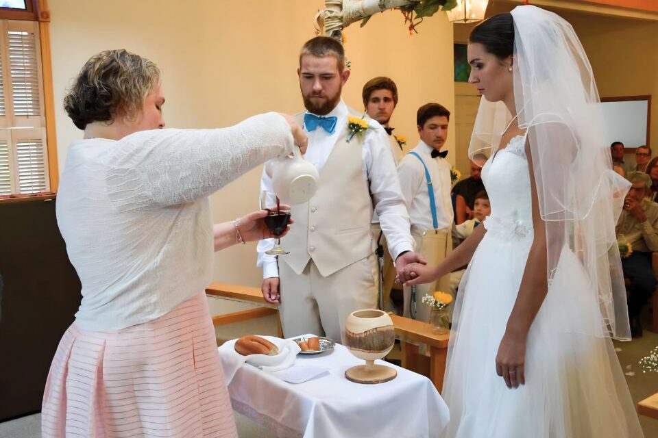 Pastor serving communion to a couple