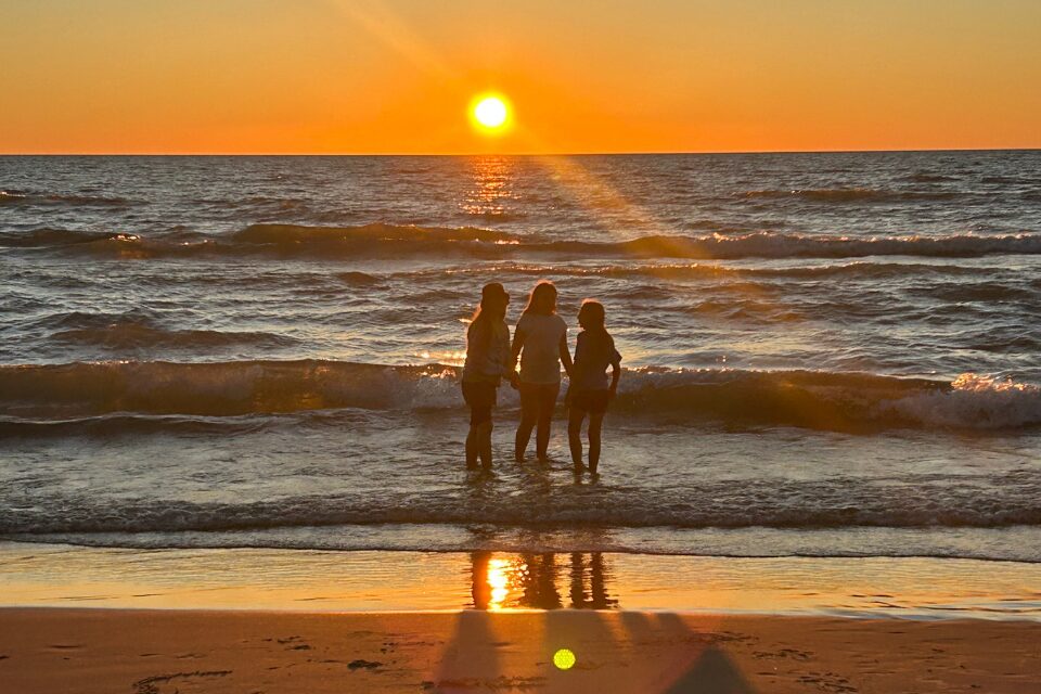 Youth on a beach at sunset