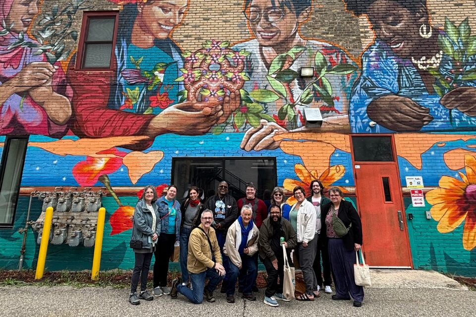 People standing in front of a mural
