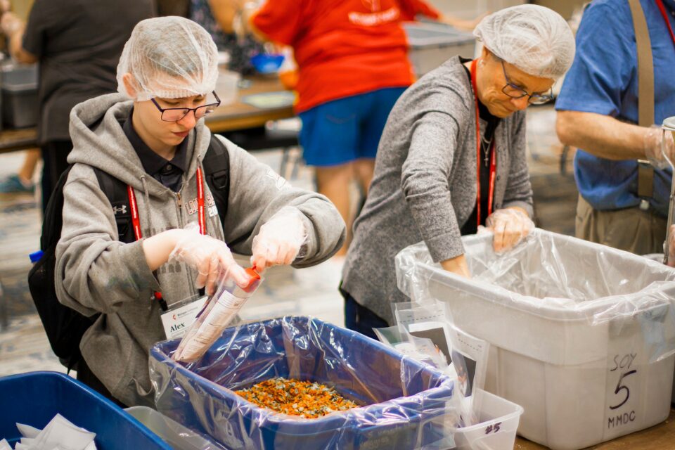 People packing meal packs for hunger relief