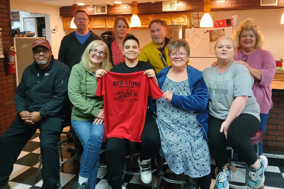 Volunteers hold T-shirt