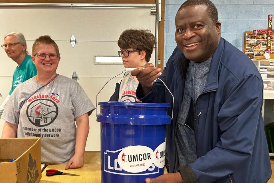 Volunteers showing a flood bucket