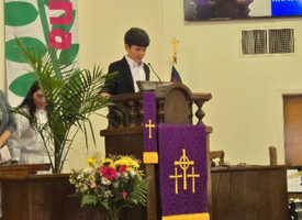 Child reading scripture in worship