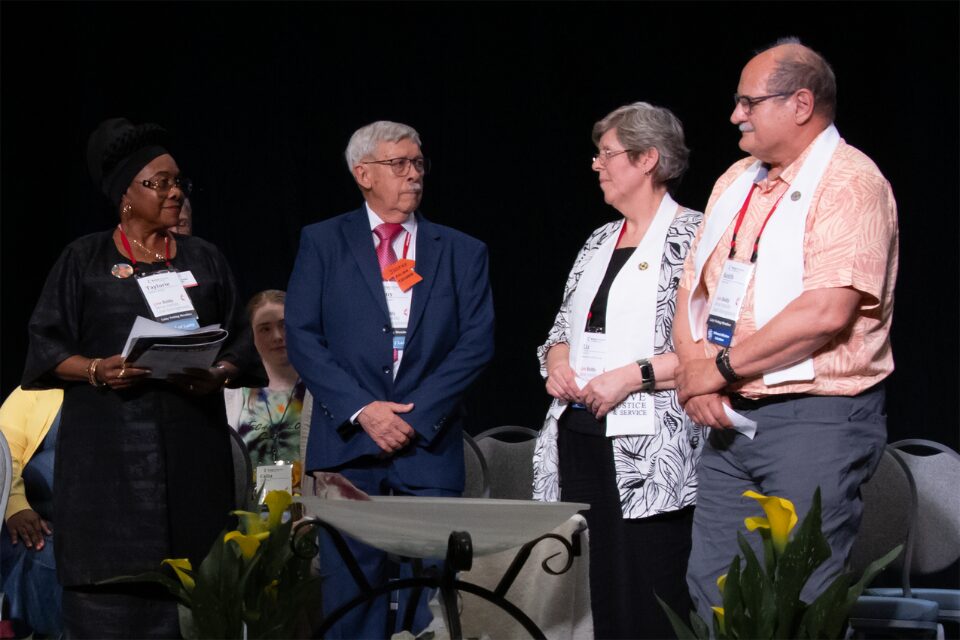 Two people receiving an honor for service
