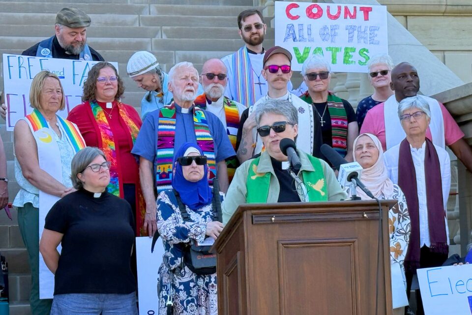 Woman speaking at a rally in Lansing