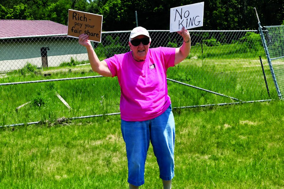 Woman holding signs at a rally