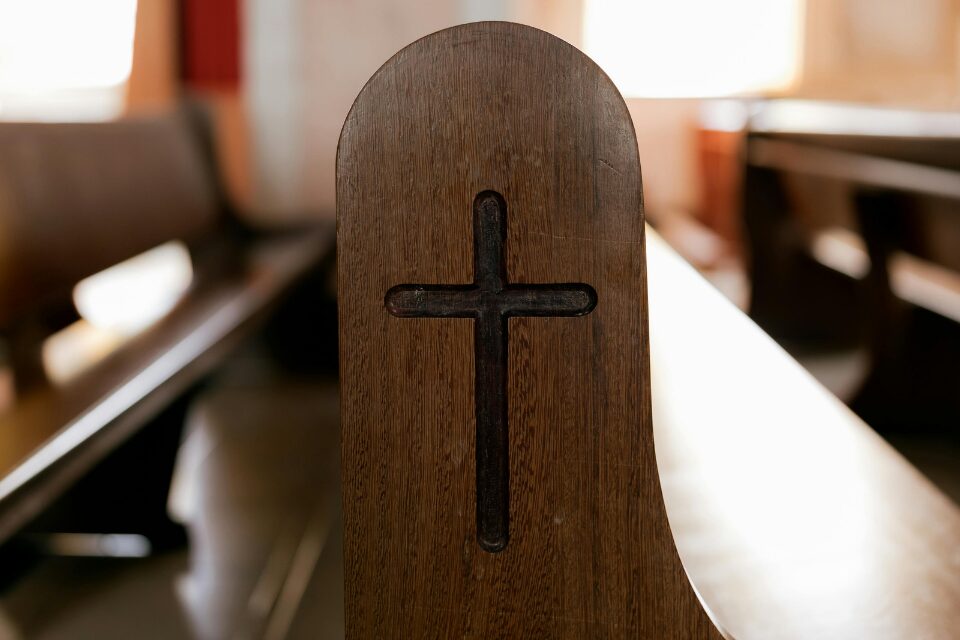 Pew with cross symbol on the end
