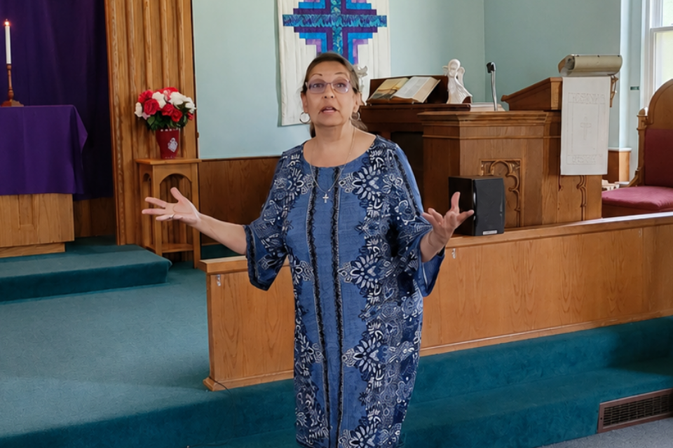 woman speaking in front of church