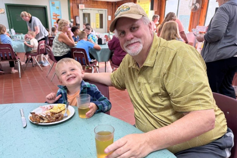 Granddad and his grandson at camp