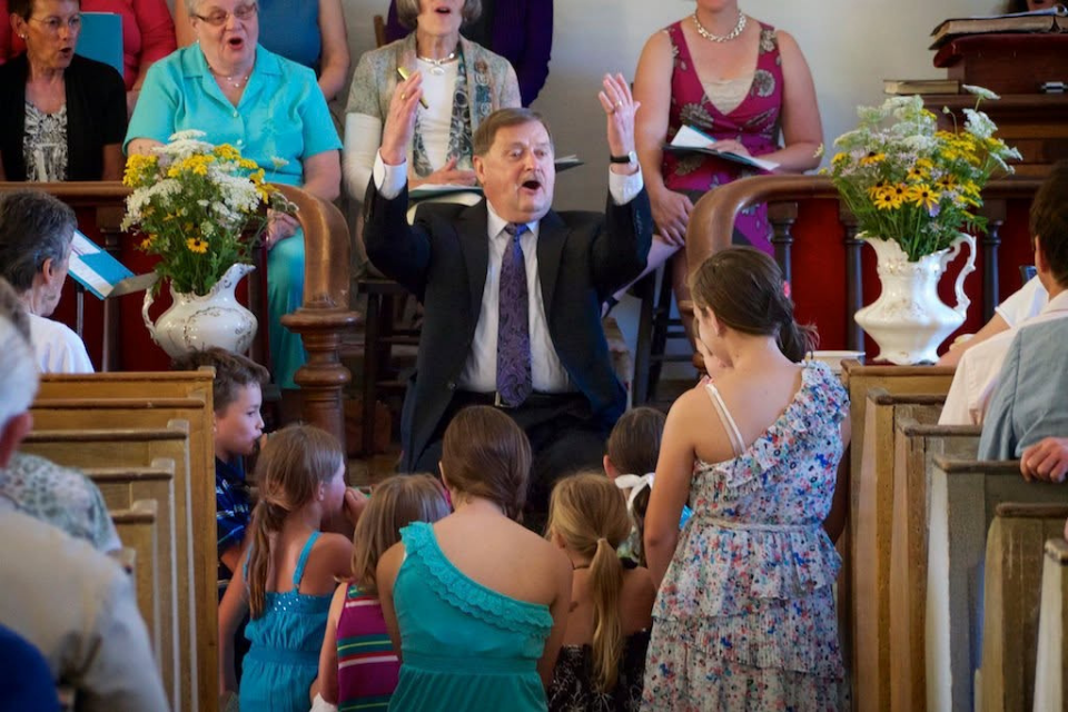 Man leading worship and singing in a church