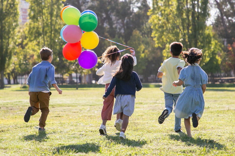 Children running with balloons