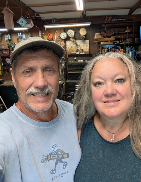 Man and woman posing in a garage